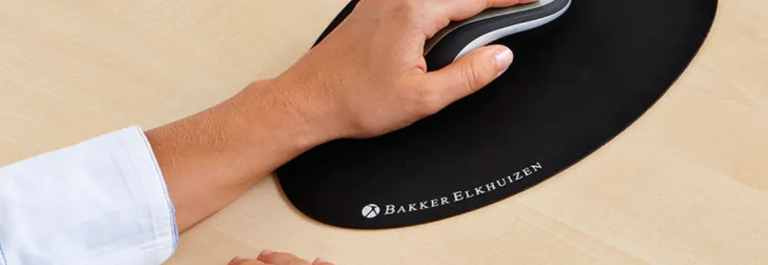 main entrain d'utiliser une souris ergonomique sur un tapis de souris ergonomique